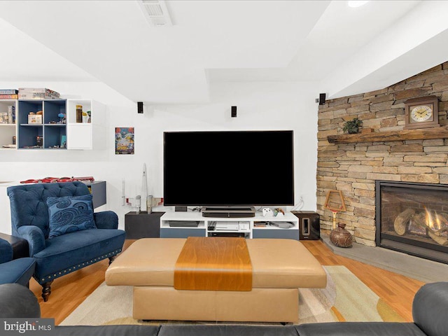 living room featuring a fireplace and light hardwood / wood-style flooring