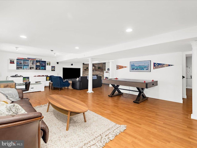 living room featuring wood-type flooring and ornate columns