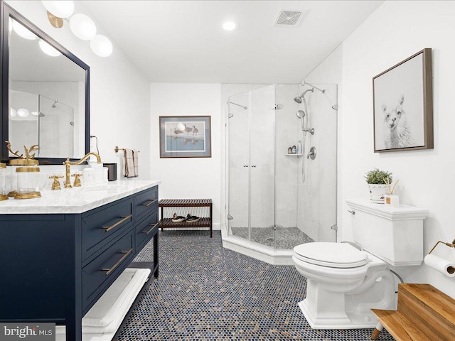 bathroom featuring vanity, toilet, an enclosed shower, and tile patterned flooring