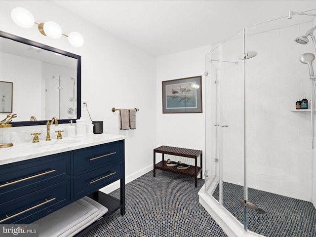 bathroom with an enclosed shower, vanity, and tile patterned floors