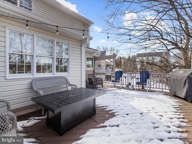 snow covered deck featuring area for grilling