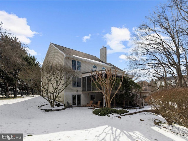 view of snow covered rear of property