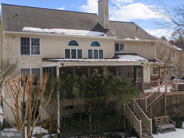 rear view of property featuring a sunroom