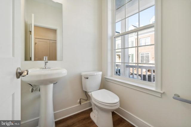 bathroom featuring hardwood / wood-style floors and toilet