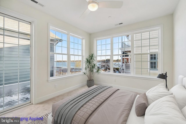 bedroom with light colored carpet and ceiling fan