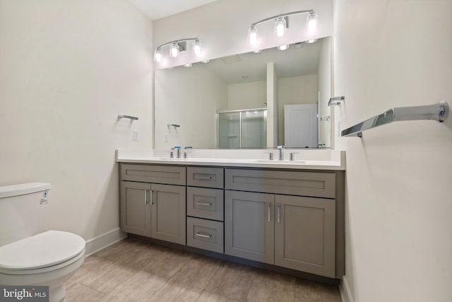 bathroom featuring vanity, toilet, an enclosed shower, and hardwood / wood-style floors