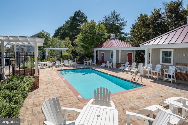 view of pool featuring an outdoor structure, a pergola, and a patio