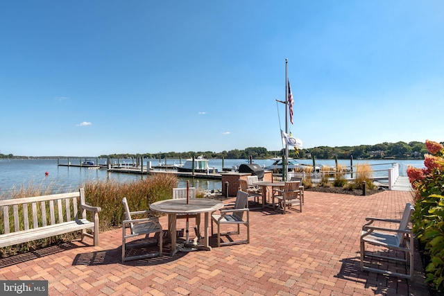 view of patio / terrace with a boat dock and a water view