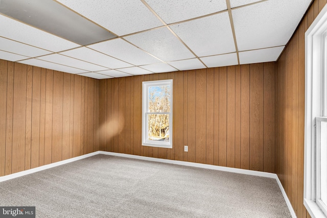 unfurnished room featuring carpet floors and a paneled ceiling