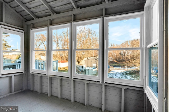 unfurnished sunroom with lofted ceiling