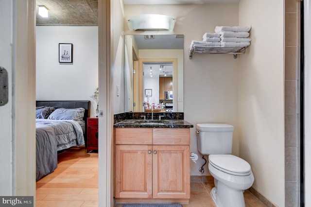 bathroom featuring hardwood / wood-style flooring, vanity, and toilet