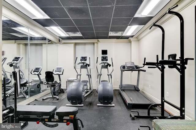 exercise room featuring a paneled ceiling