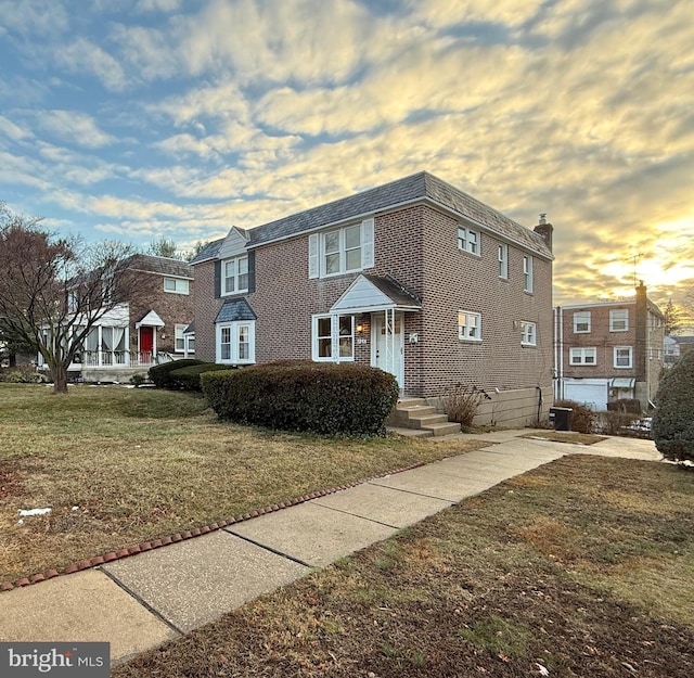 view of front of house featuring a lawn and central AC