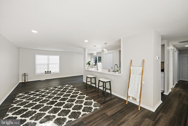 unfurnished room featuring sink and dark wood-type flooring