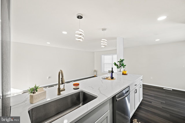 kitchen with white cabinets, dishwasher, sink, hanging light fixtures, and light stone counters