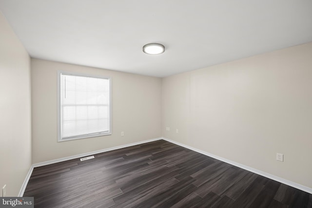 empty room featuring dark hardwood / wood-style floors