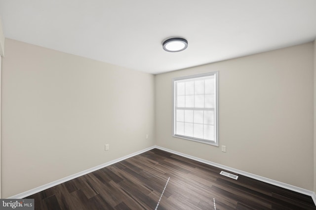 empty room with dark hardwood / wood-style floors