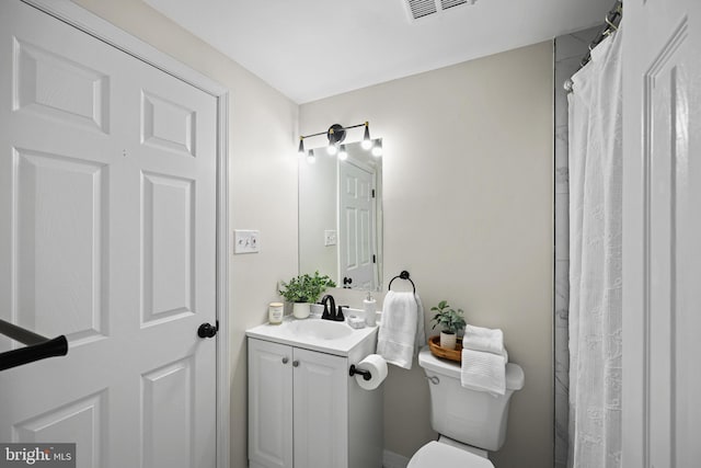 bathroom with vanity, toilet, and a shower with curtain