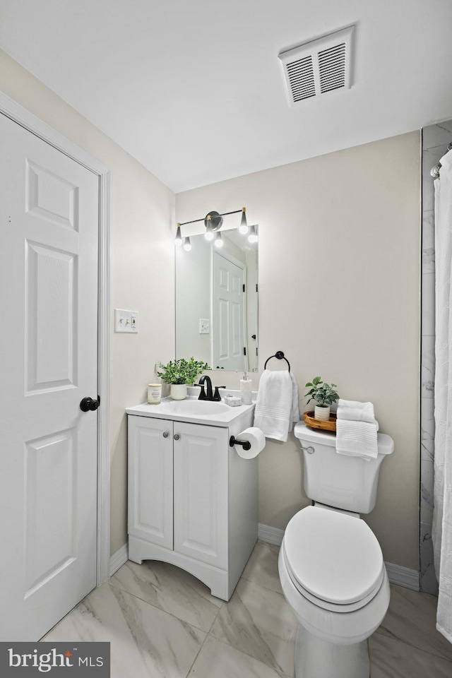 bathroom featuring toilet and vanity