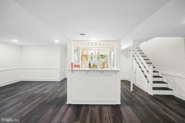 kitchen featuring white cabinetry, dark wood-type flooring, and a breakfast bar