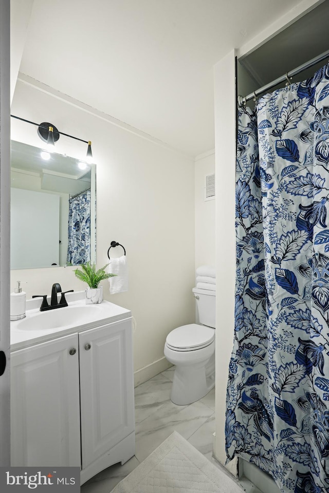 bathroom with vanity, toilet, and walk in shower