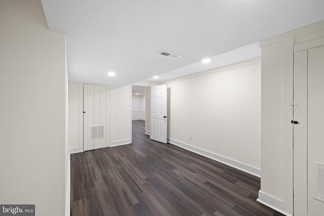 basement with dark hardwood / wood-style flooring