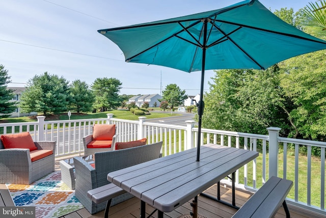 deck featuring an outdoor living space and a yard