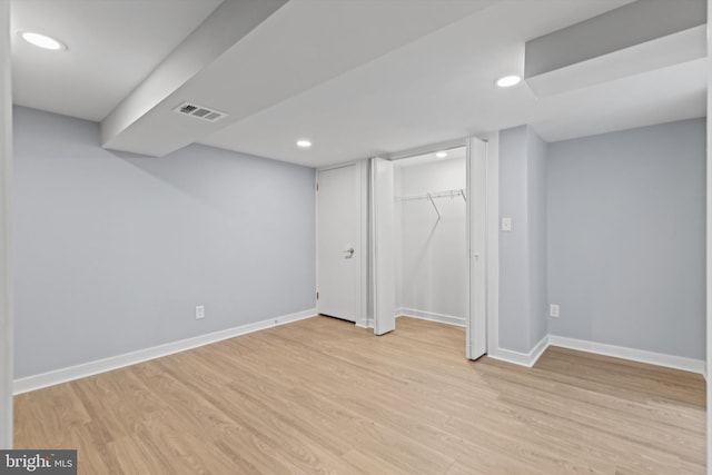 basement with light hardwood / wood-style floors