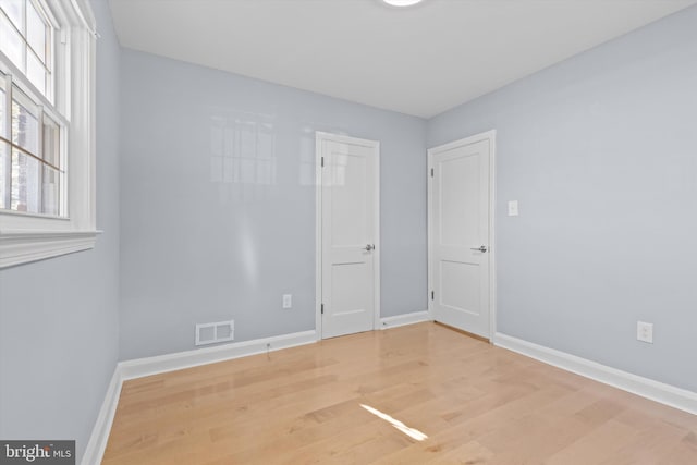 spare room with hardwood / wood-style floors