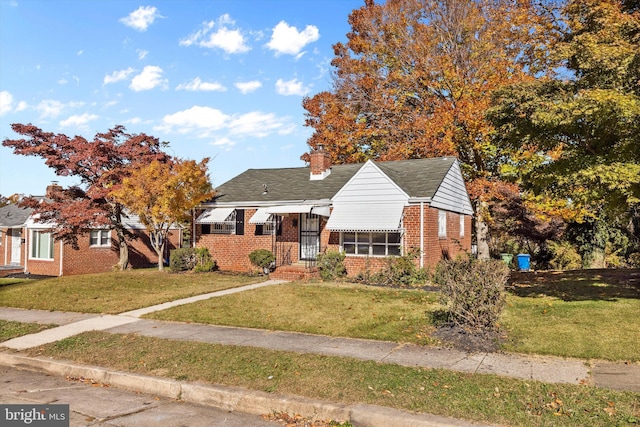 bungalow-style home featuring a front lawn