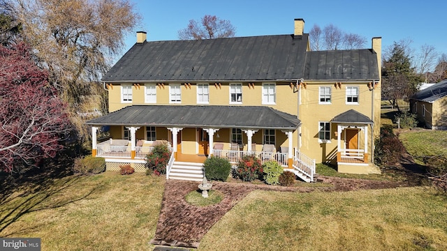 view of front facade with a front lawn and a porch