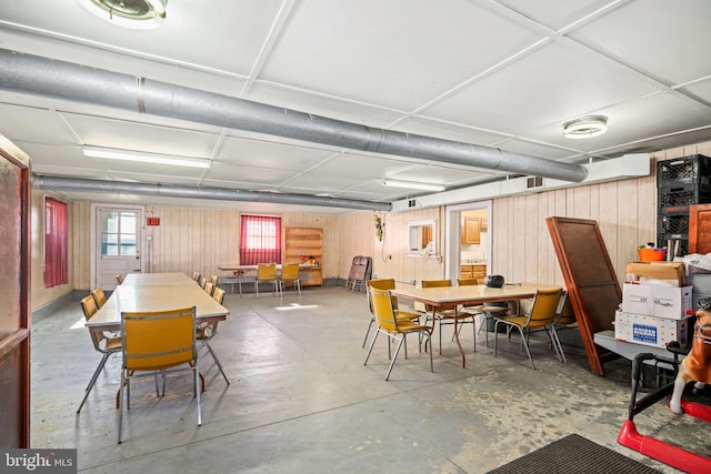 basement featuring wooden walls