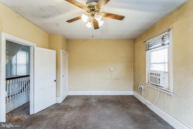 unfurnished room featuring ceiling fan, a wealth of natural light, and cooling unit