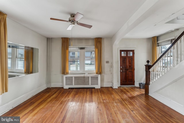 foyer with ceiling fan, hardwood / wood-style floors, and radiator heating unit