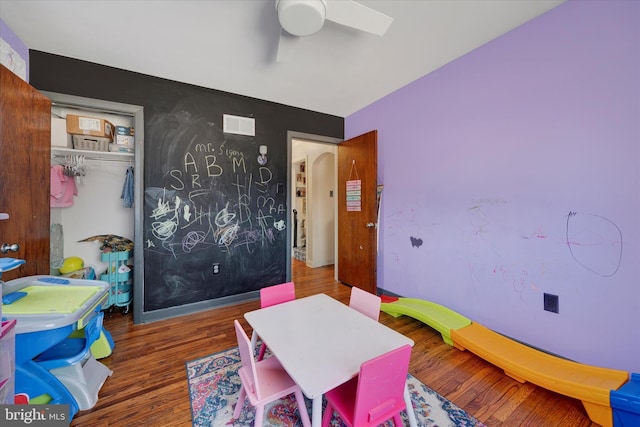 recreation room featuring dark wood-type flooring and ceiling fan