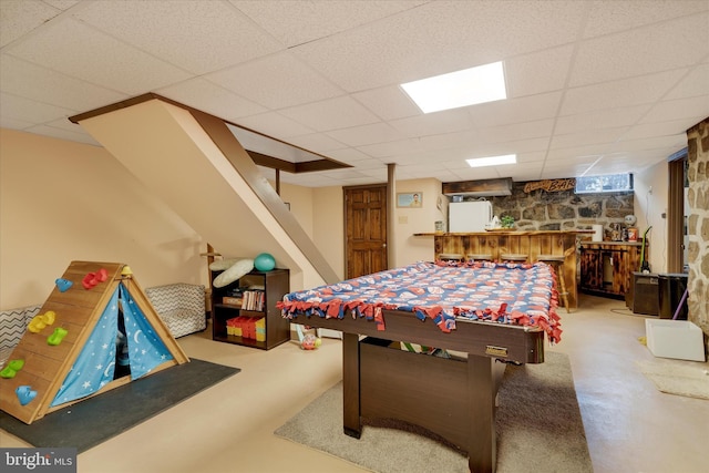 recreation room with a drop ceiling