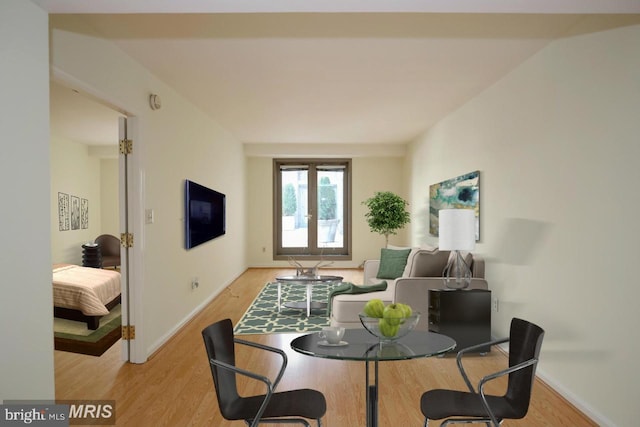 dining space with light hardwood / wood-style floors and french doors