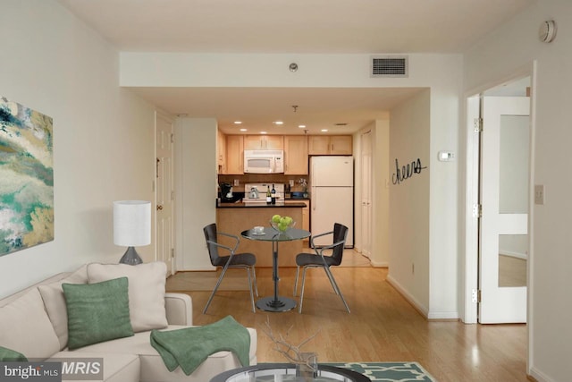 living room with light hardwood / wood-style floors