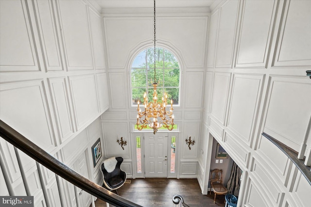 entryway with a chandelier and dark hardwood / wood-style floors