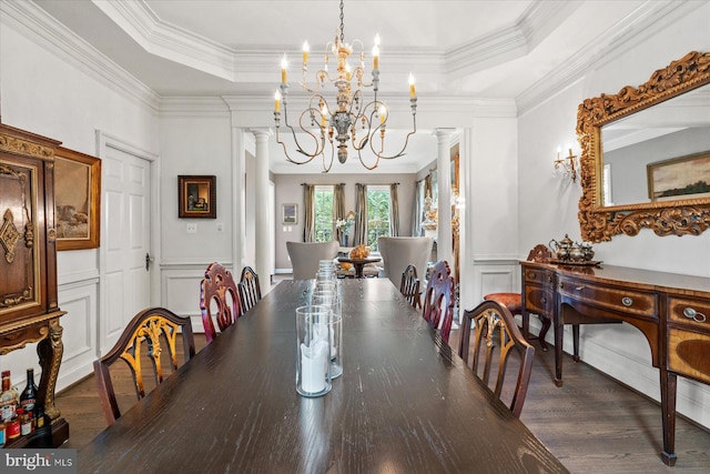 dining room featuring a chandelier, crown molding, and a raised ceiling