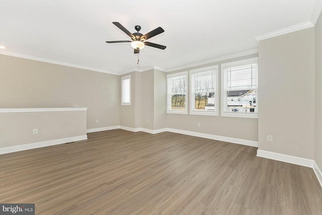 unfurnished room with wood-type flooring, a wealth of natural light, ornamental molding, and ceiling fan