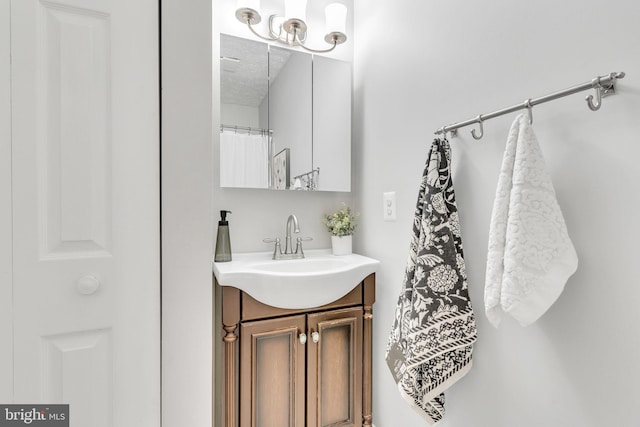 bathroom featuring a textured ceiling and vanity