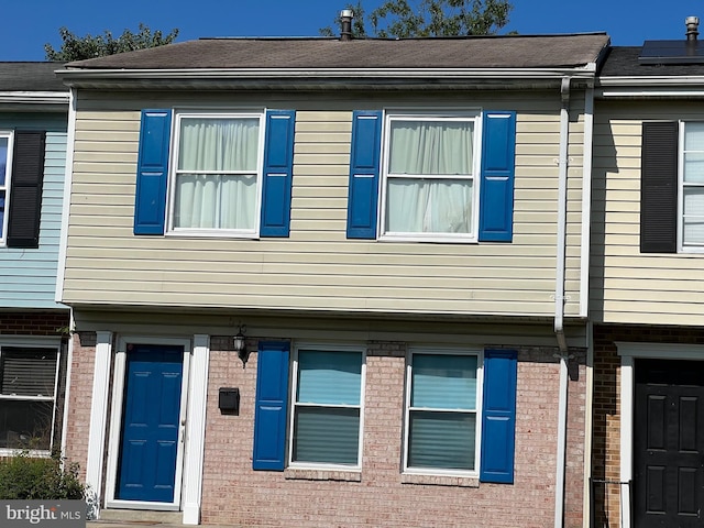 view of side of home with solar panels