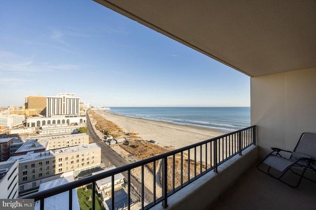 balcony featuring a beach view and a water view