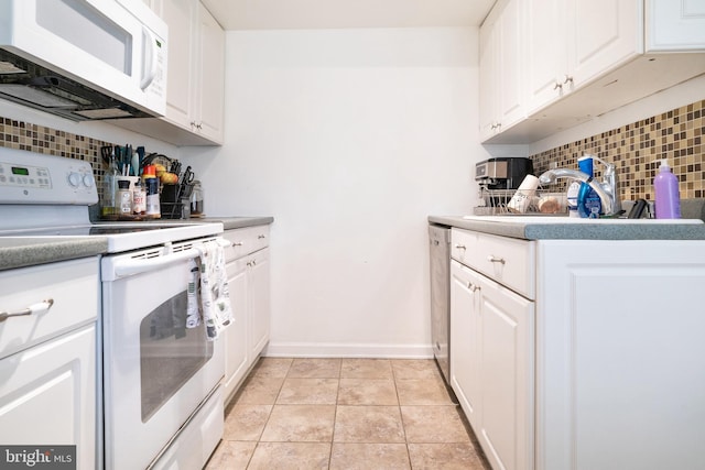 kitchen with white appliances, white cabinetry, sink, backsplash, and light tile patterned flooring