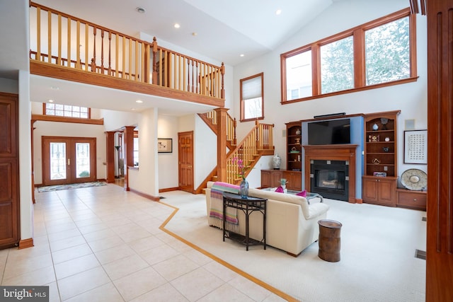 living room with high vaulted ceiling, french doors, and light tile patterned flooring