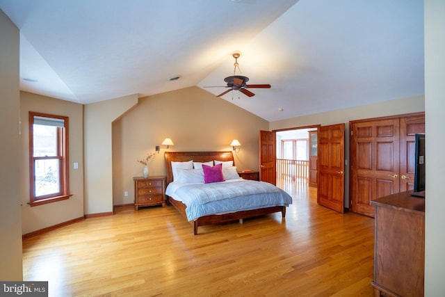 bedroom featuring ceiling fan, light hardwood / wood-style floors, and lofted ceiling