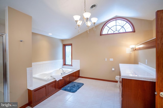 bathroom featuring plenty of natural light, a washtub, lofted ceiling, and an inviting chandelier