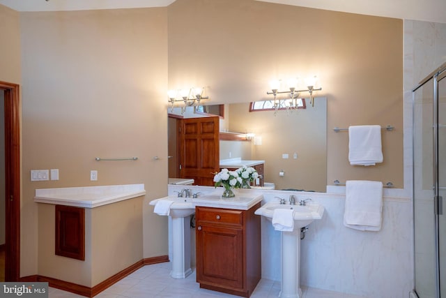 bathroom with an enclosed shower, sink, and tile patterned floors