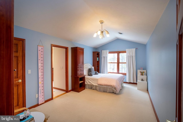 carpeted bedroom with a chandelier and vaulted ceiling